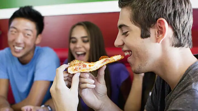 person eating pizza after fiberotomy