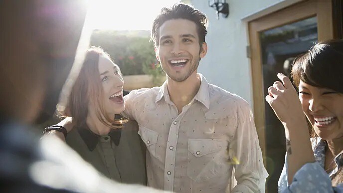 man smiling after getting his buccal exostosis examined by dentist