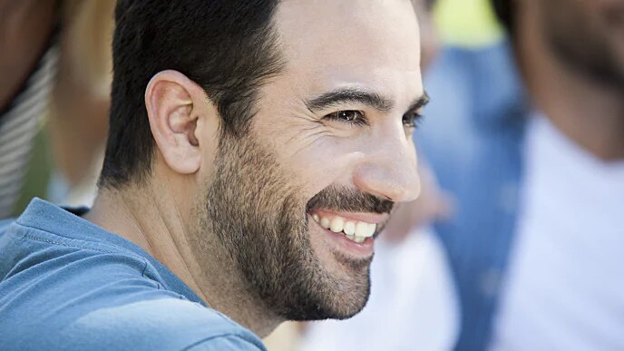 A man with a beard smiling