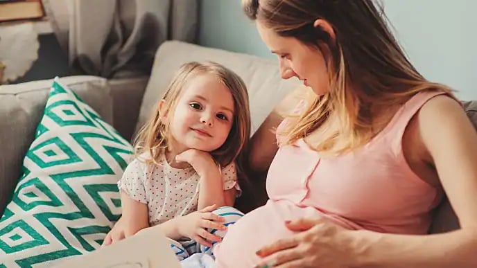 pregnant woman talking with daughter