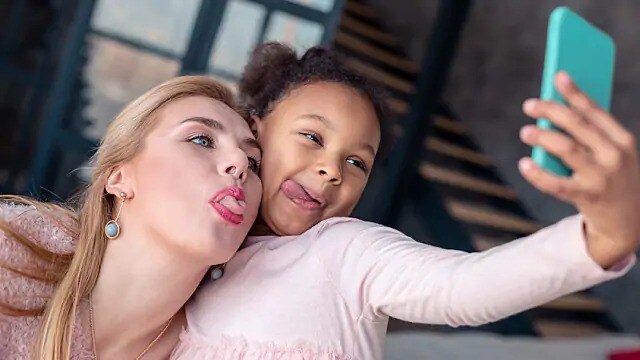 mother and daughter sticking their tongues out using the lingual artery