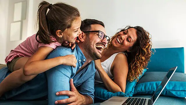 family of three laughing together