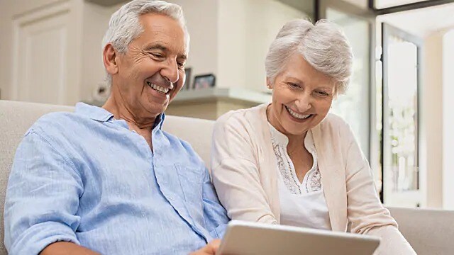 older couple smiling after successful dental procedures