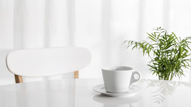 White cup on kitchen table White cup on kitchen table