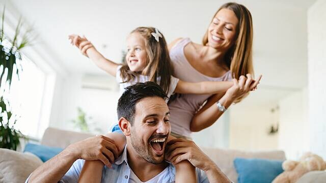 man smiling with family after dental procedure