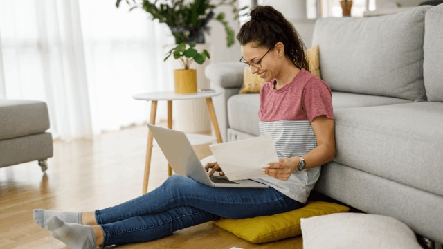 Young woman working at home with laptop