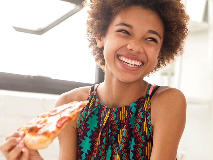 Two girls eating pizza