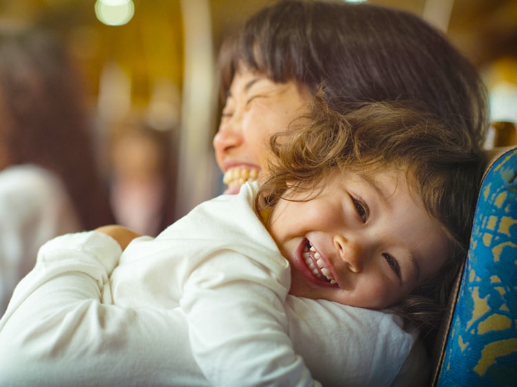 toddler smiling while being held