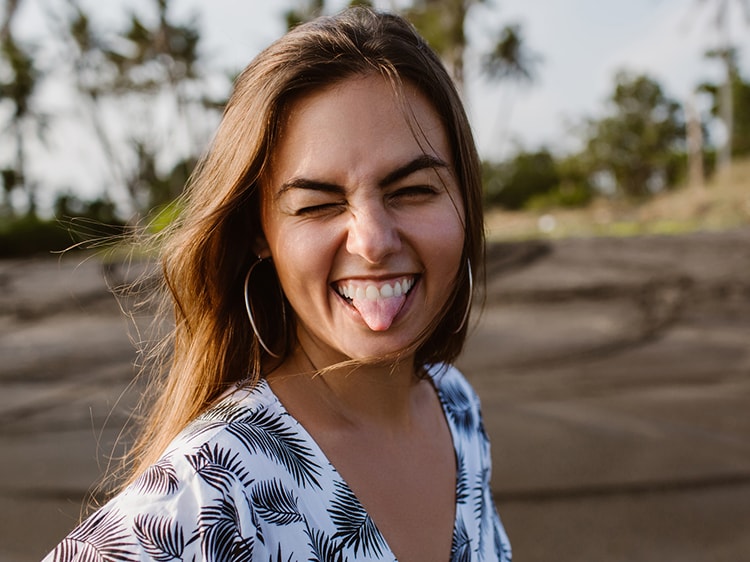 woman smiling while sticking out her tongue