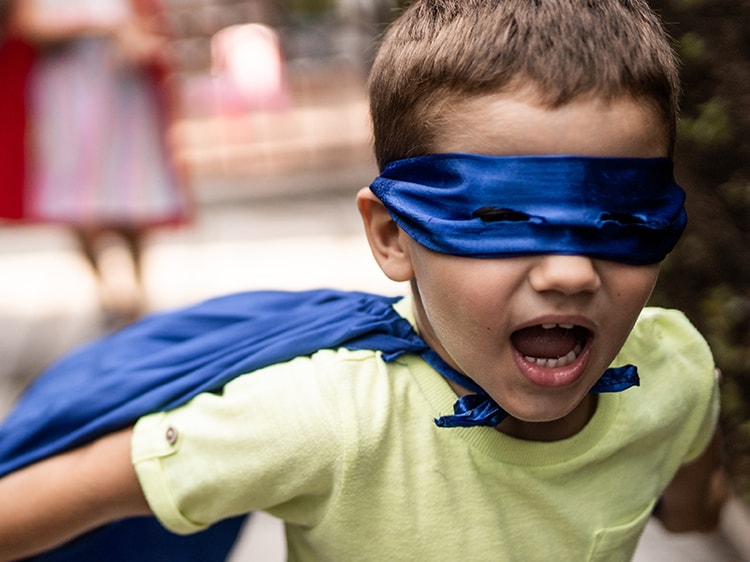 child dressed up as super hero