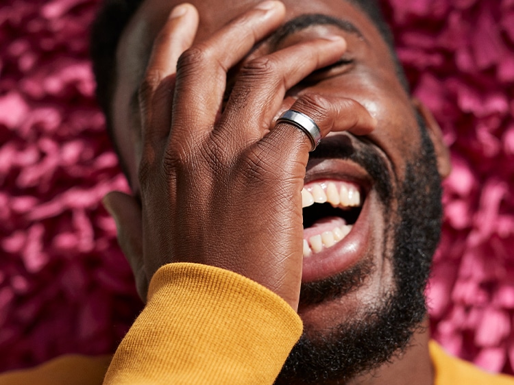 man covering his face while smiling