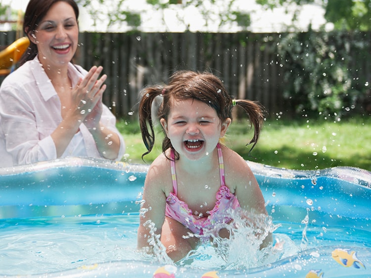 little girl playing on pool