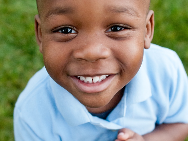 close up of smiling boy looking up