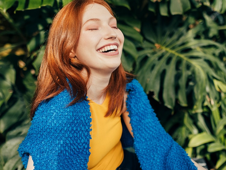 woman smiling with her eyes closed