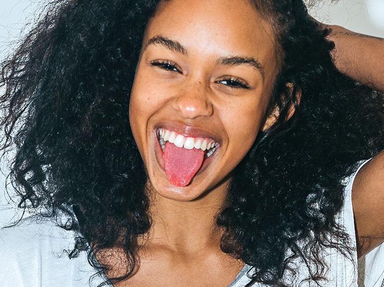 A teen girl showing a tongue