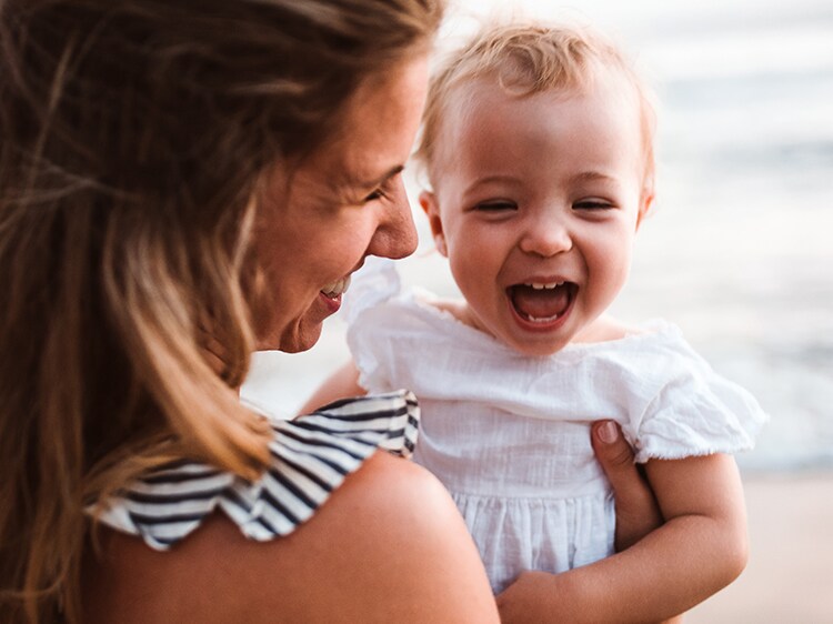 woman holding smiling child
