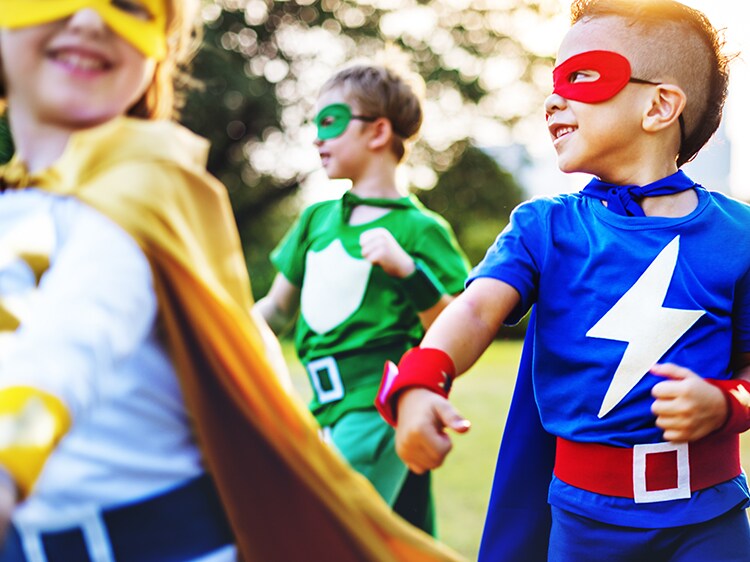 group of children dressed up as super heroes