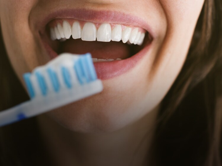 brushing with Colgate toothbrush