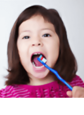 girl brushing her teeth with Colgate toothbrush