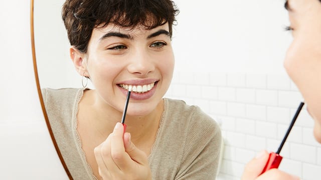 Woman using whitening pen
