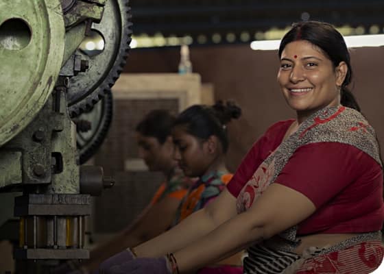 woman smiling while working a machinery