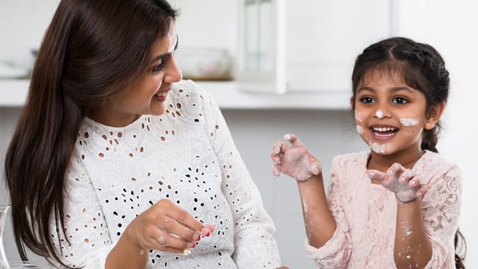 Little girl cooking with her mother