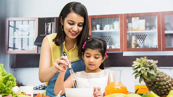 Mother and daughter cooking dinner