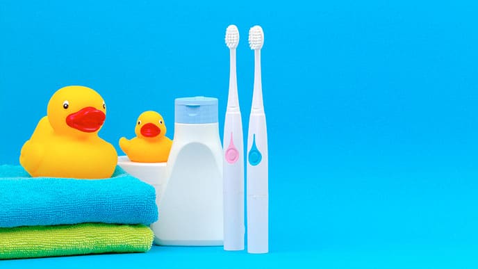 Two kid electric toothbrushes with cute bath accessories