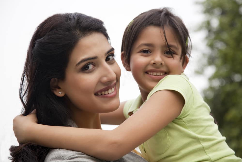 Portrait of a mother holding her daughter