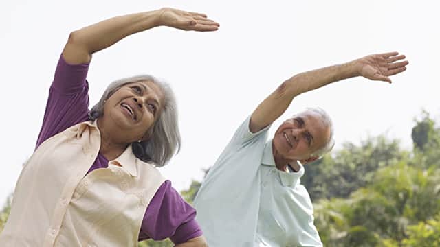 Older Woman and Man doing aerobic exercise outdoors