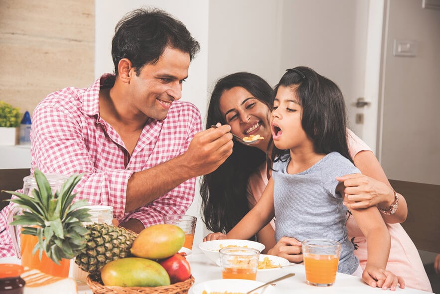 Young family having breakfast