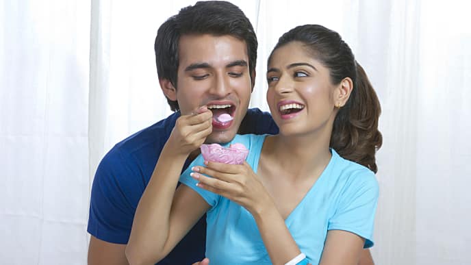 Smiling woman feeding her husband