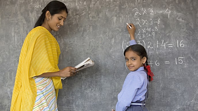 student writes on the board