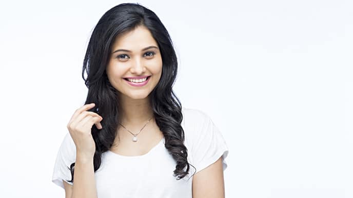 a young lady with a bright, radiant smile, showcasing her transformation from yellow teeth to sparkling white