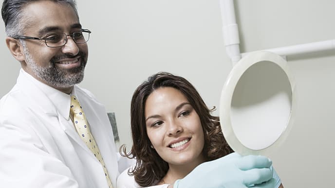 Dentist with patient who has tooth pain