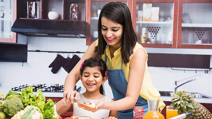 Mother and daughter cooking dinner