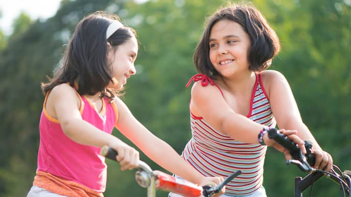 Two friends riding bicycle