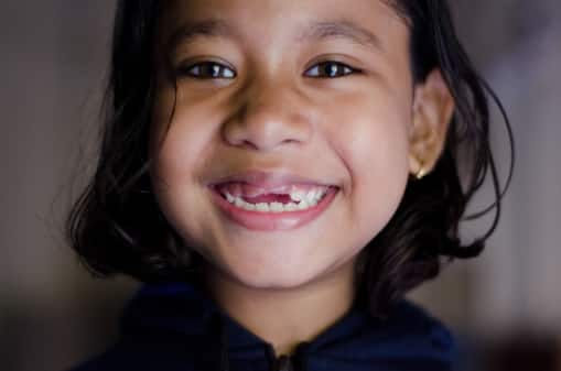 A young girl who lost her kids teeth  