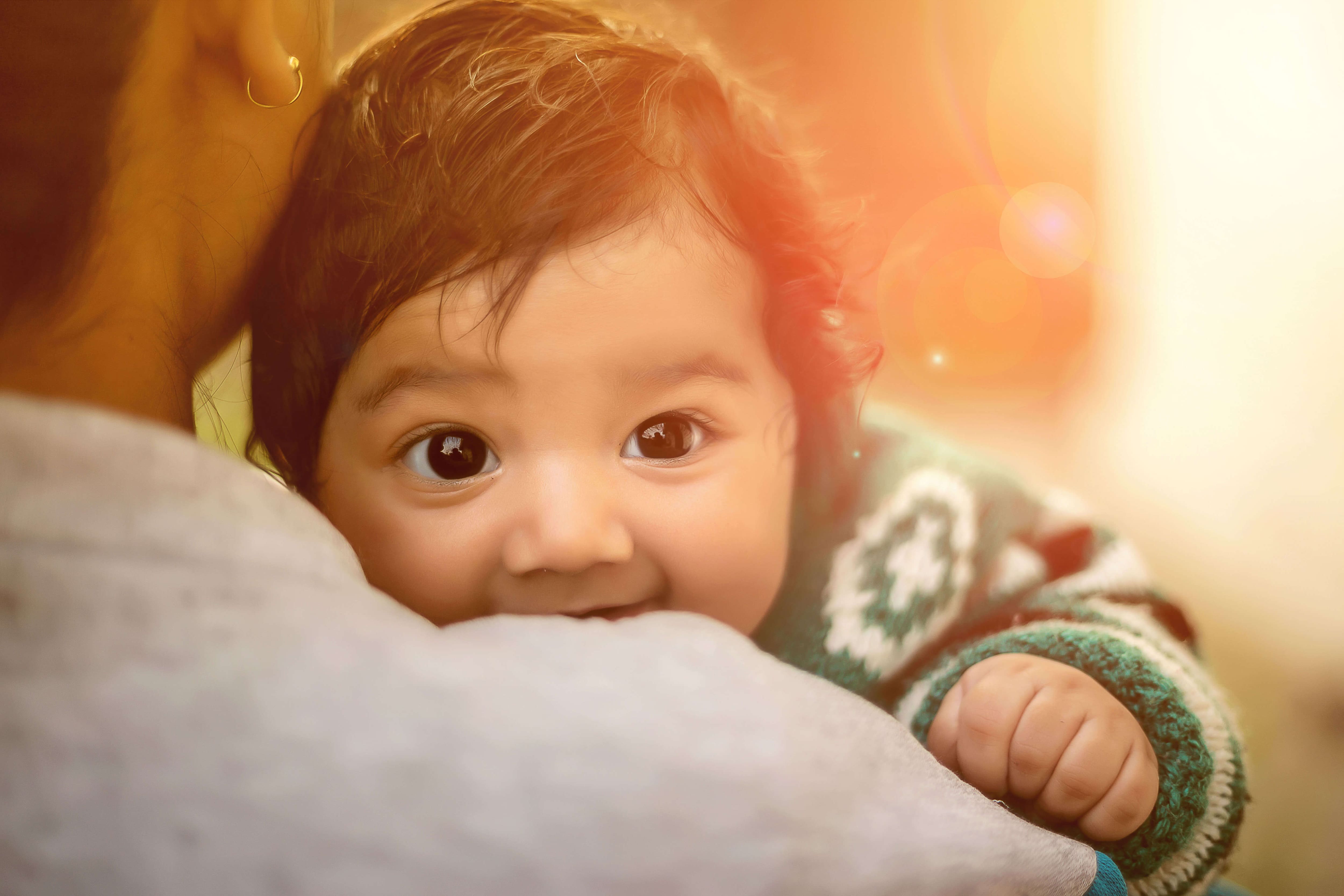 Baby smiling with his mother