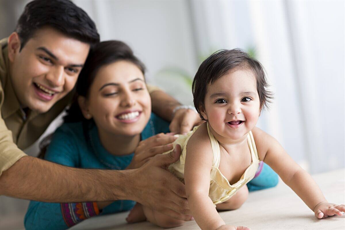 A couple playing with their baby