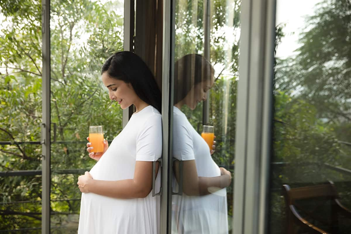 Pregnant woman drinking juice