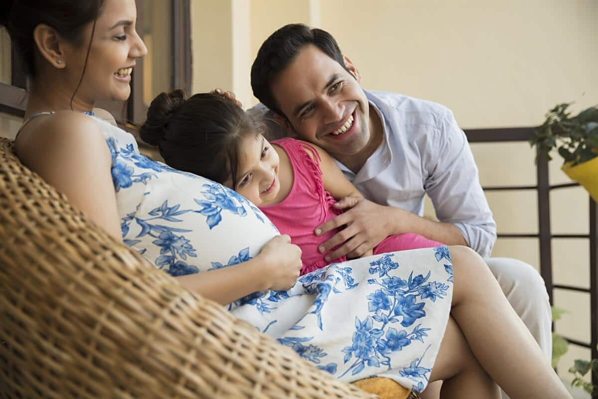 Pregnant woman with her husband and daughter