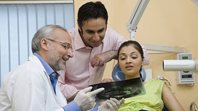dentist showing dental x-ray to the patient
