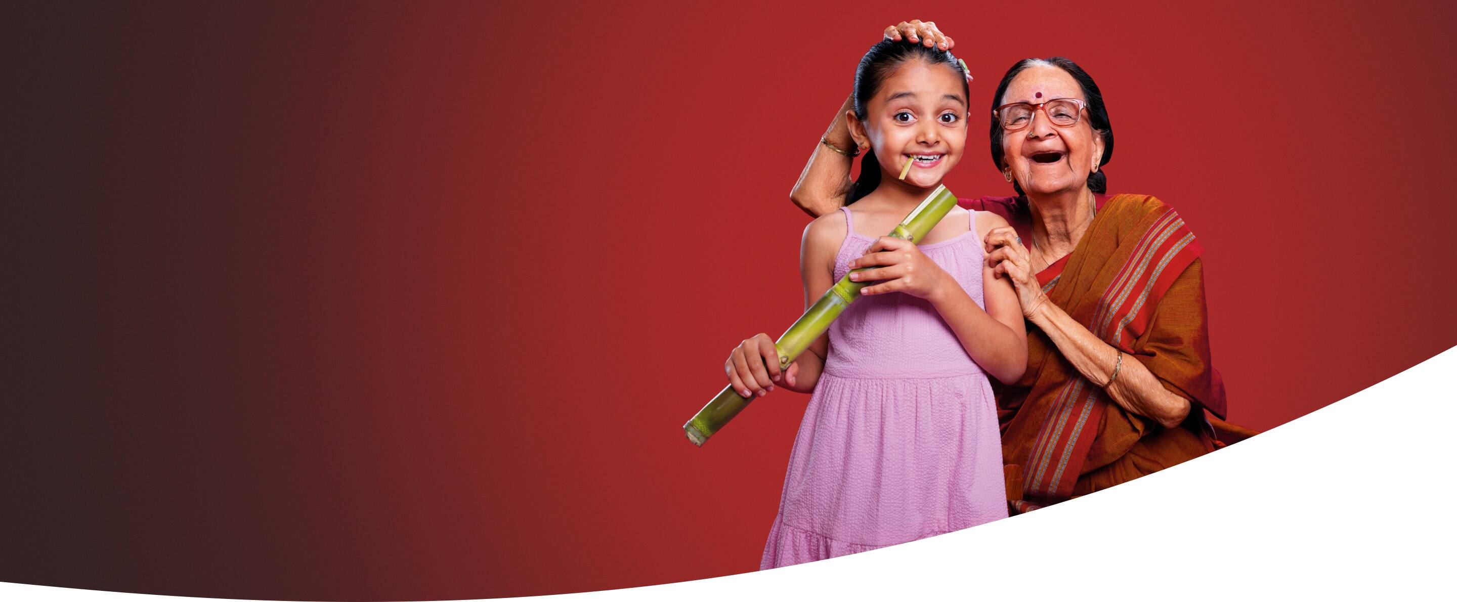 mother smiling at her daughter, while the daughter holds a bag full of apples