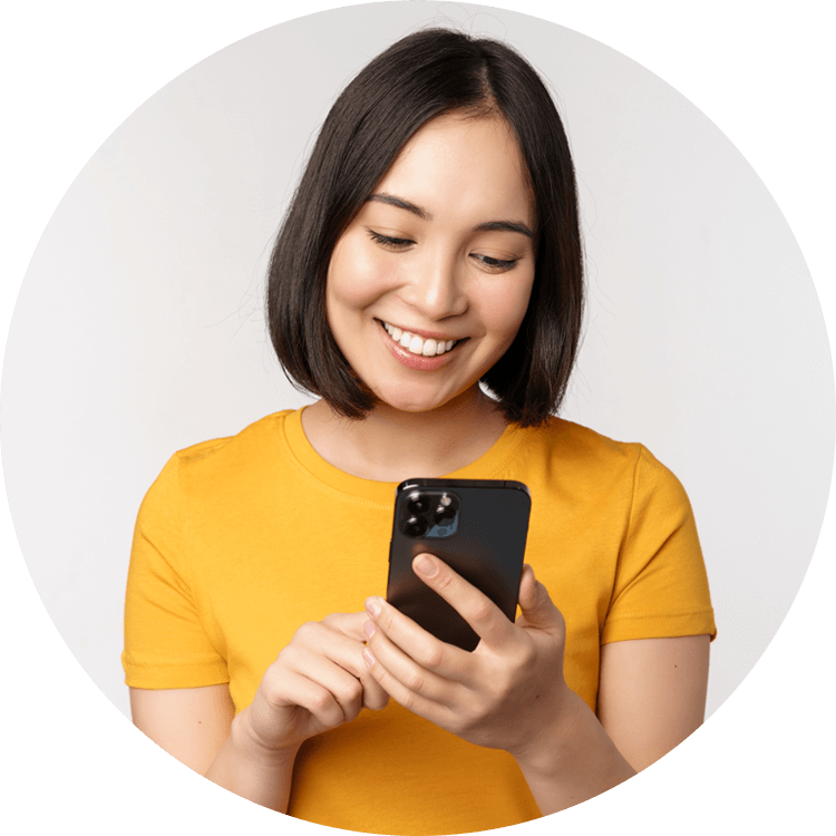 Asian lady looking at mobile phone and smiling