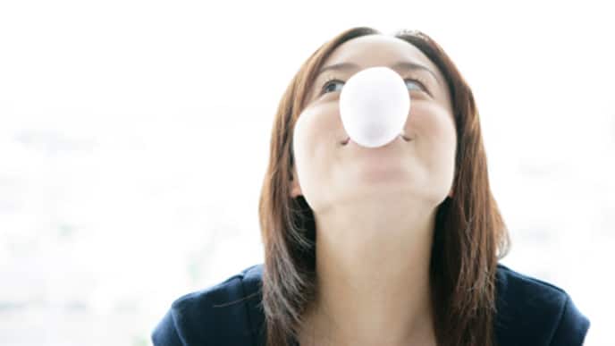 girl blowing pink bubble gum