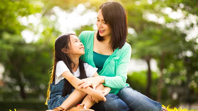 Asian mom with daughter at a park