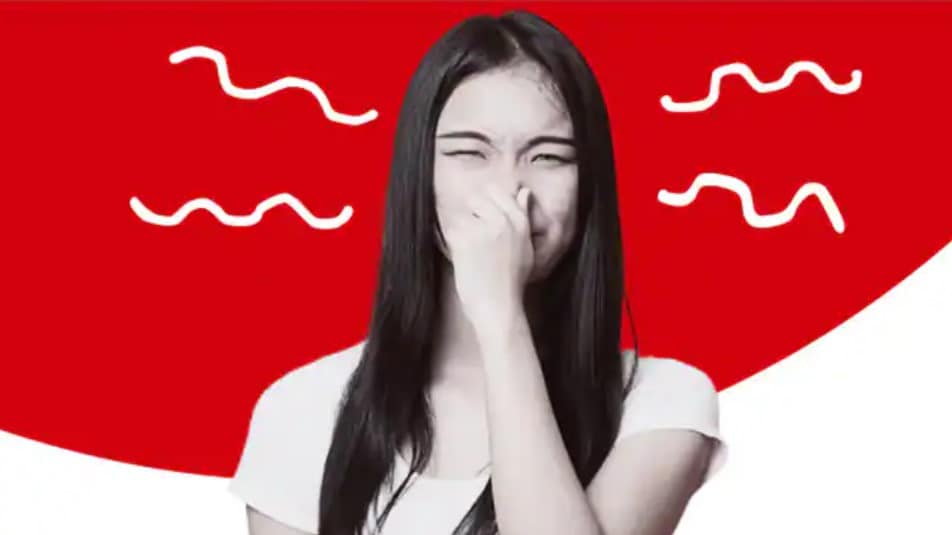 Girl closing her nose due to bad breath from stomach and other causes