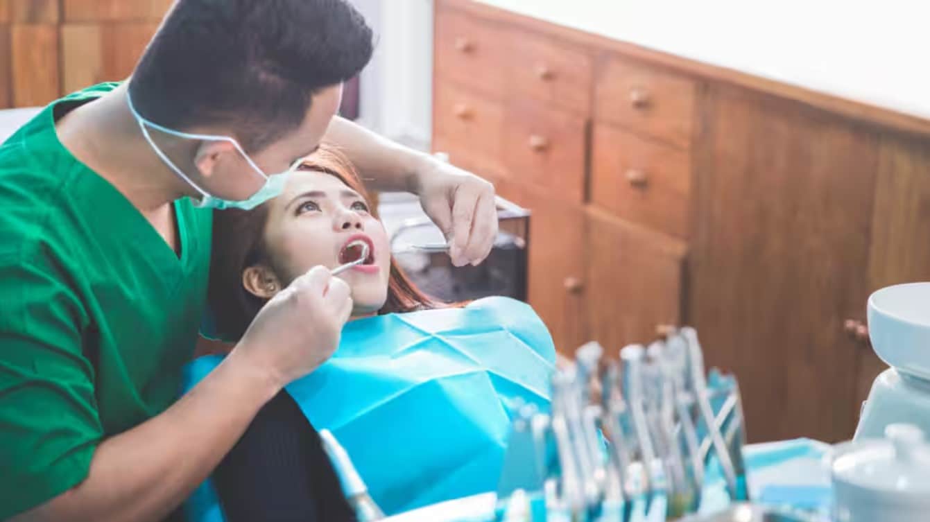 Dentist treating female patient during cavity prevention checkup 