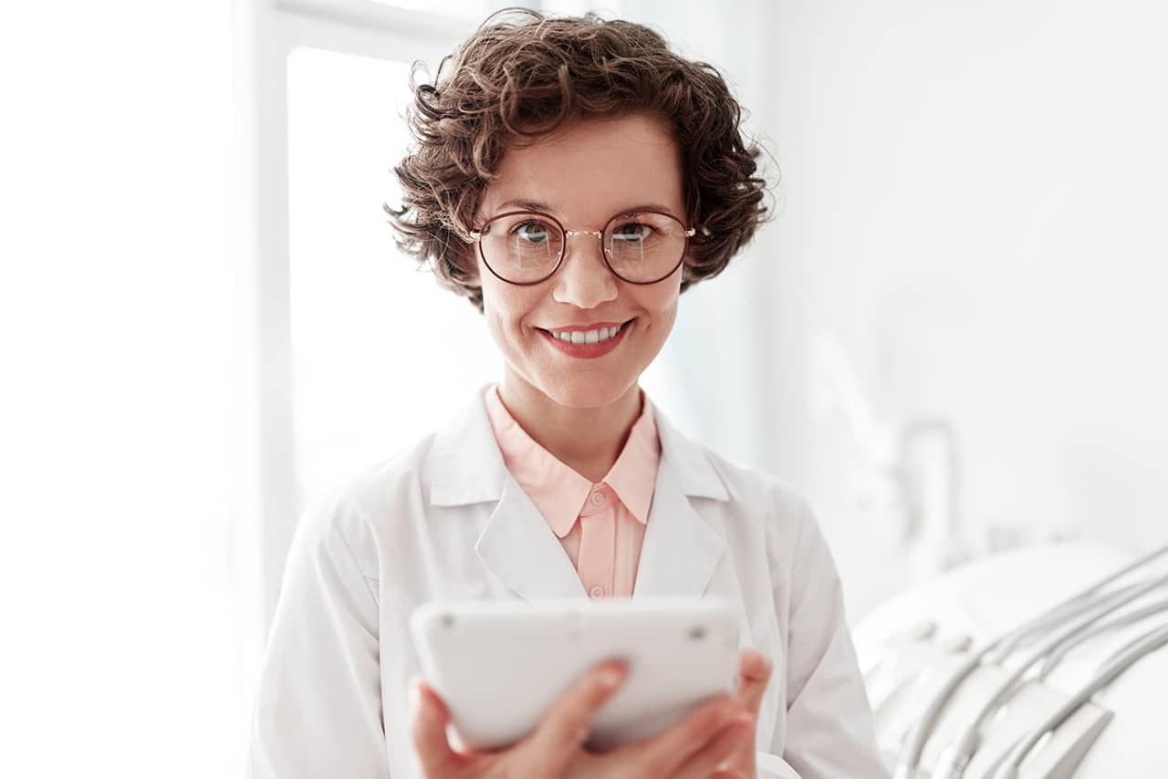 Scientist smiling while holding her tablet